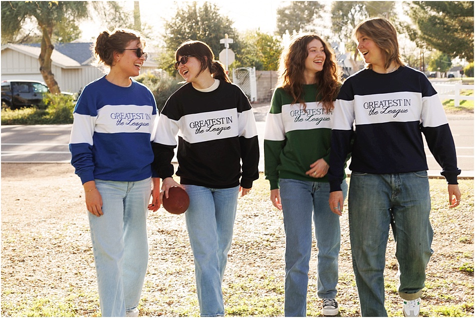 Four friends in colorblock Foolery sweatshirts walking together at sunset